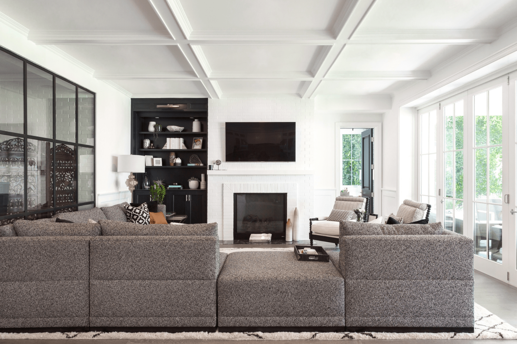 The Encino living room features a detailed ceiling above a mix of relaxed furnishings.