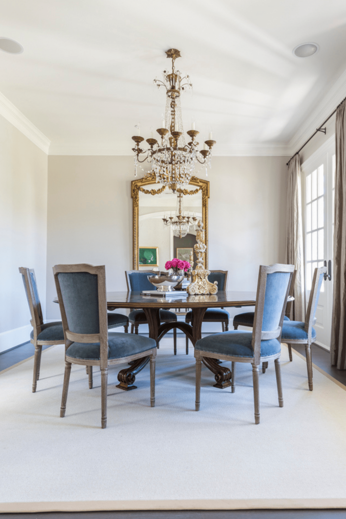 The Creekside dining area receives its French flair from the custom upholstered dining chairs and bronze finish chandelier.