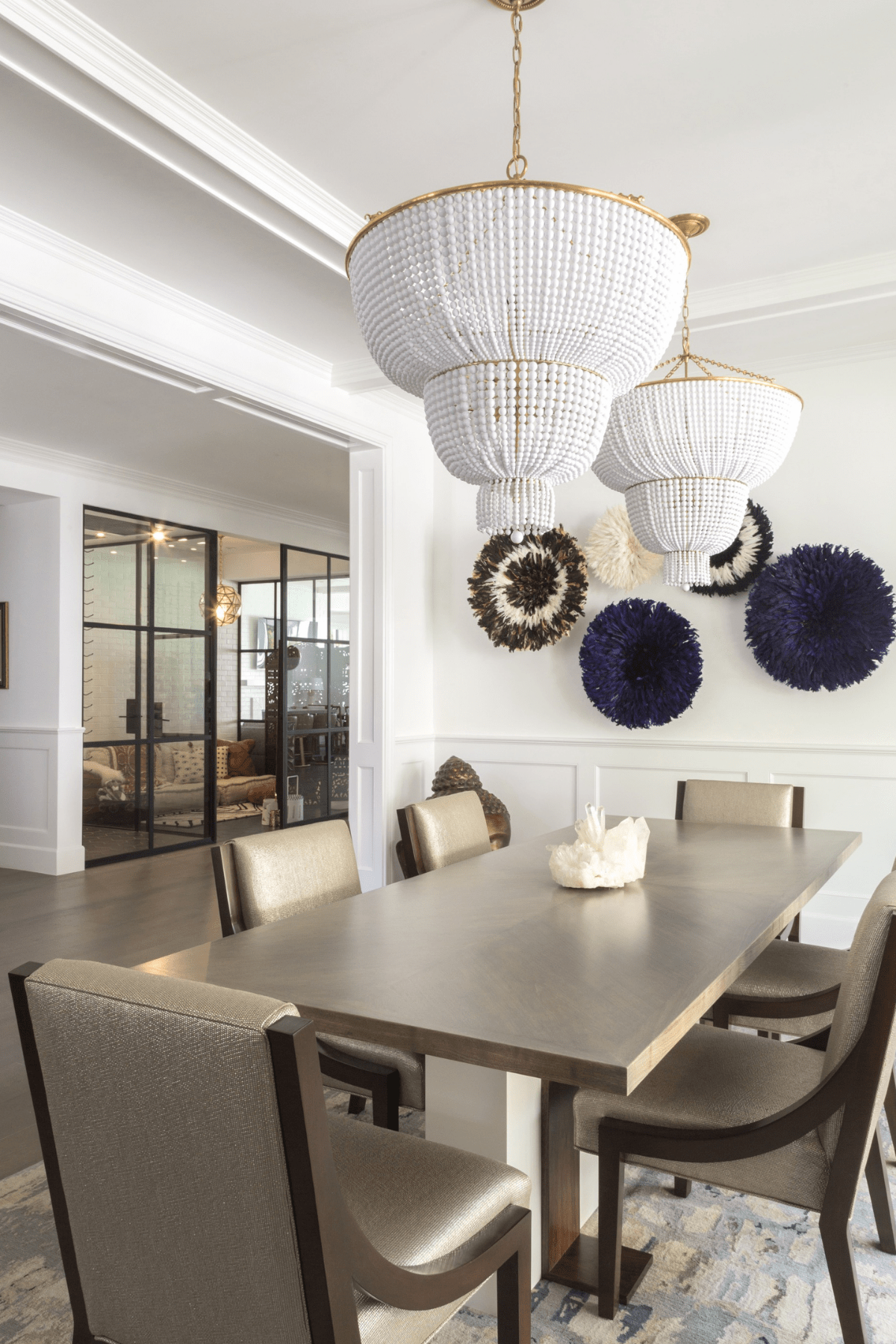 The Encino dining area with sleek furnishings and glamorous beaded chandeliers.