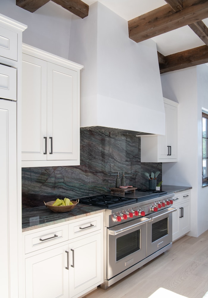 Modern kitchen interior design from Laura U with stone counters an backsplash