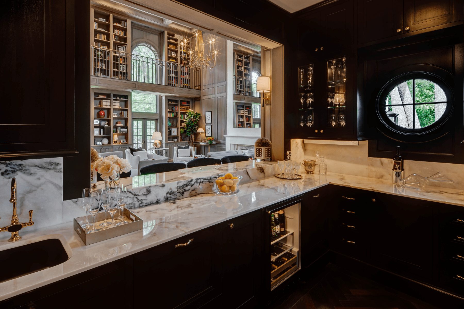 The bar at the Willowick Residence featuring sophisticated cabinetry and marble counter tops.