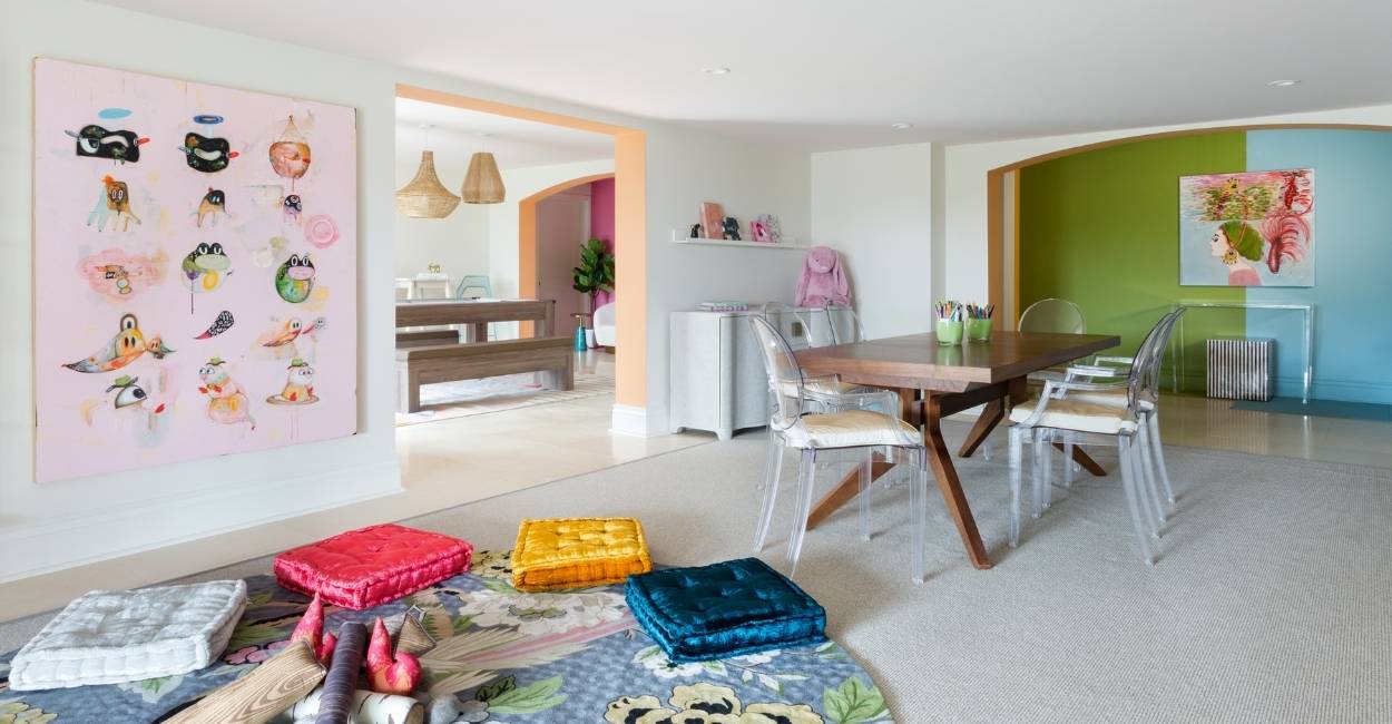 Colorful playroom with floor cushions and a floral Anthropologie rug