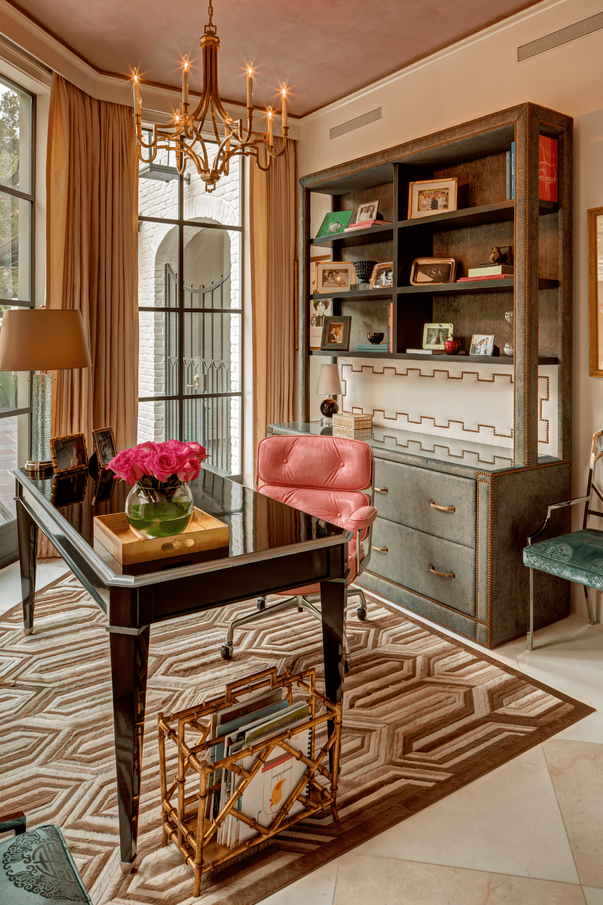 An office space at the Willowick Residence featuring vibrant furnishings and a classic chandelier.