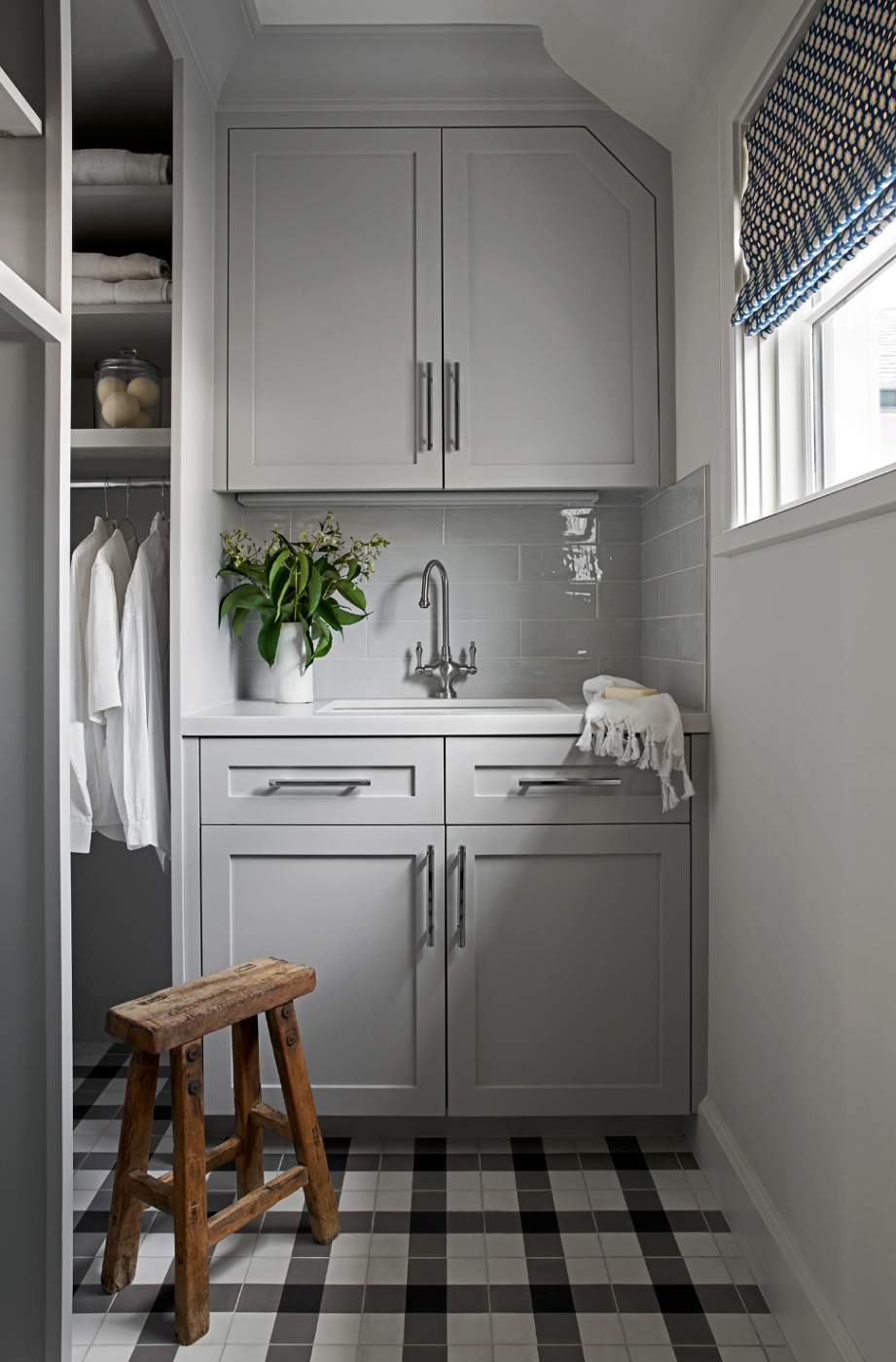 A gorgeous grey toned laundry room with a dynamic tile