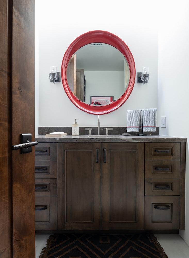 Southwestern inspired bathroom designed by Laura U with contemporary mirror