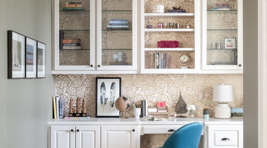 A home office in Houston, with floral wallpaper and white cabinets