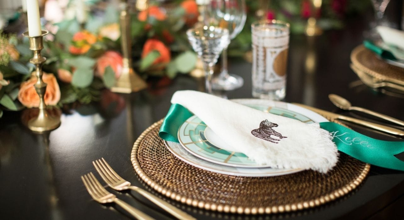 Beautiful table setting with gold tableware and white linens