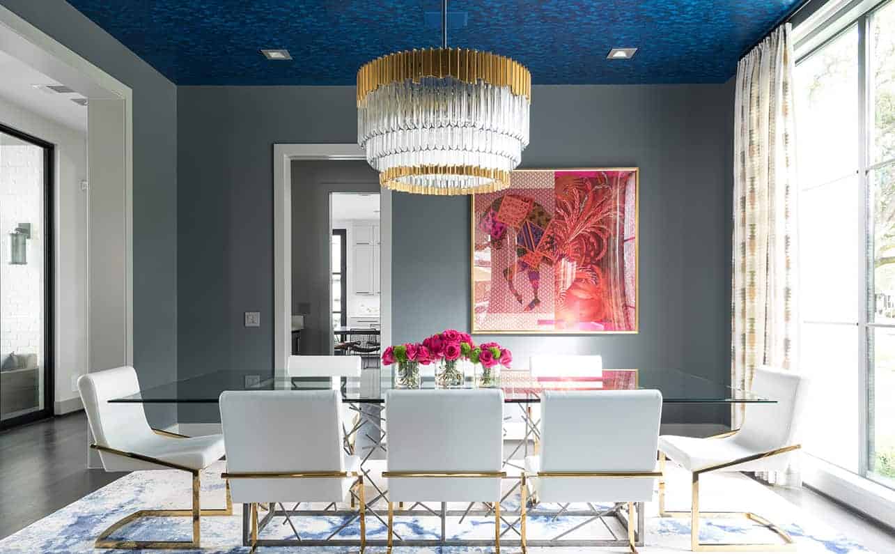 Bold dining room design with blue ceiling detail and custom dining table
