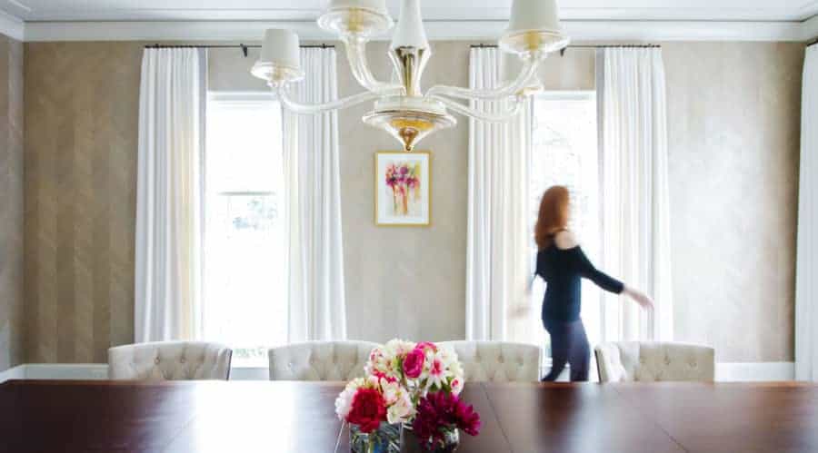 Laura U strolling through her luxury custom home interior design in Houston