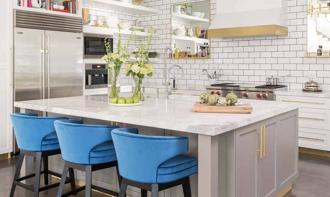 Modern kitchen design with white subway tile and blue stools, designed by Laura U Interior Design