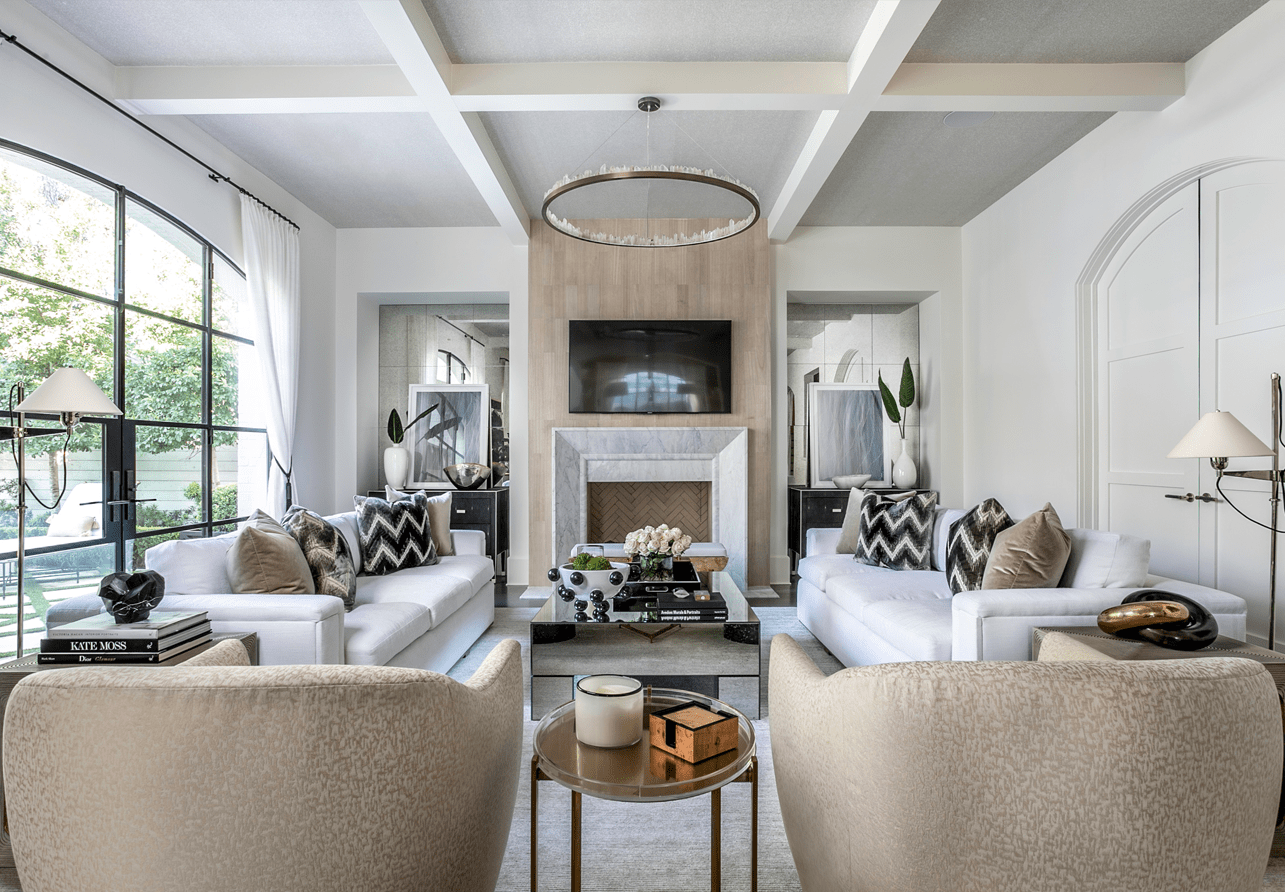 A coffered ceiling draws the eye upward in this symmetrical living room designed by Laura U