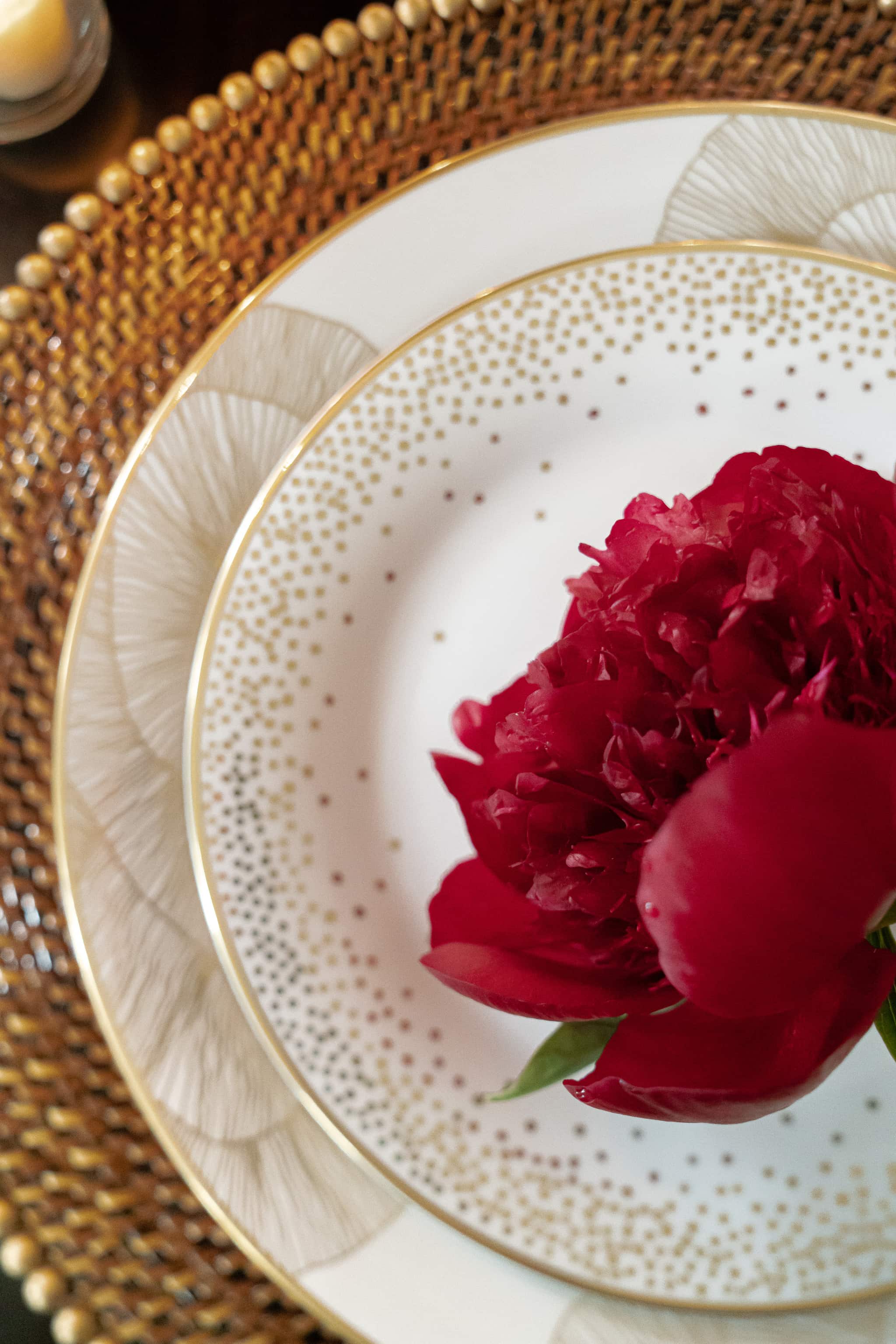 A blooming peony acts as a placecard in this elegant tablesetting by Laura U