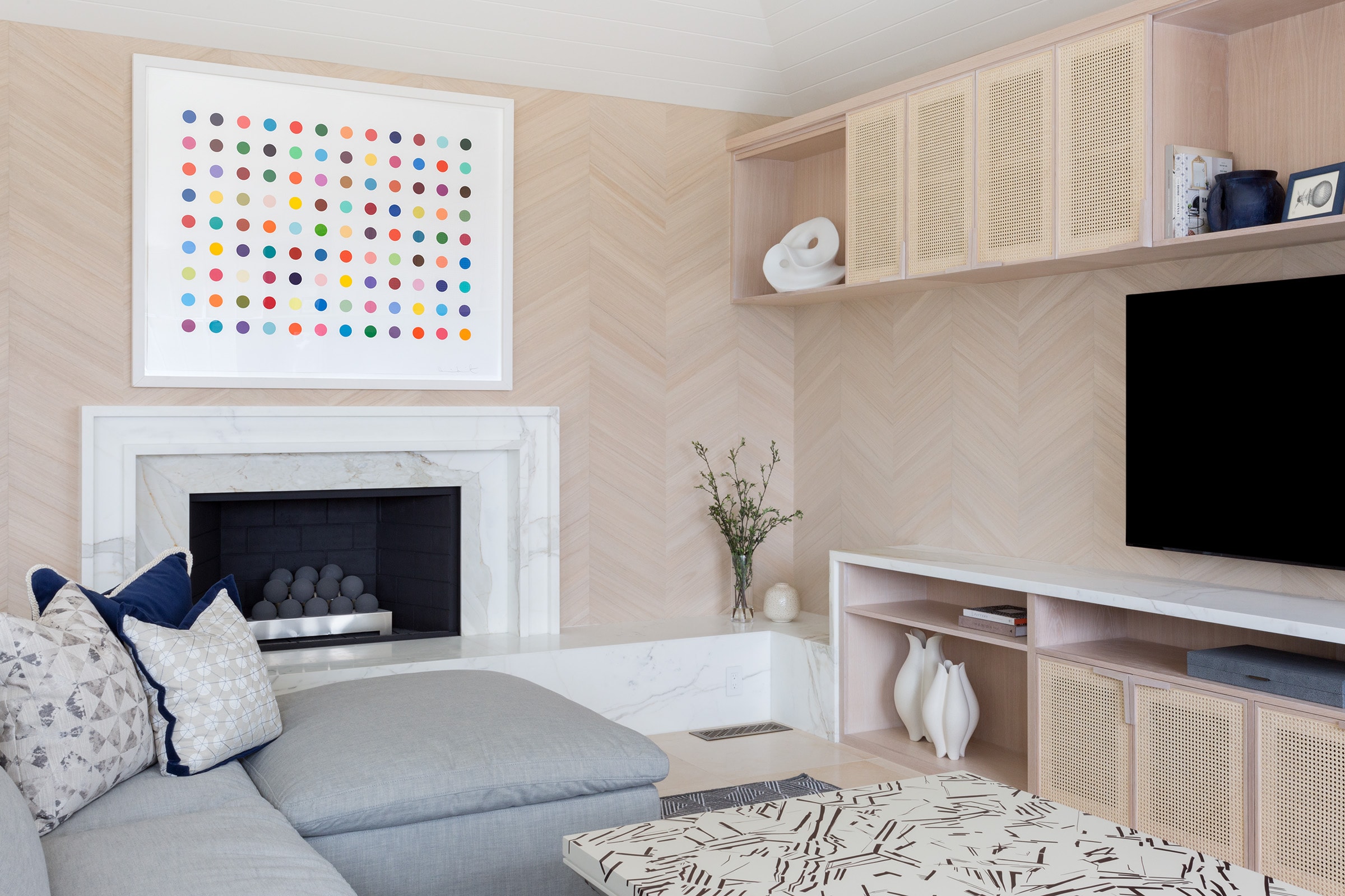 A Damien Hirst painting over a fireplace with custom millwork