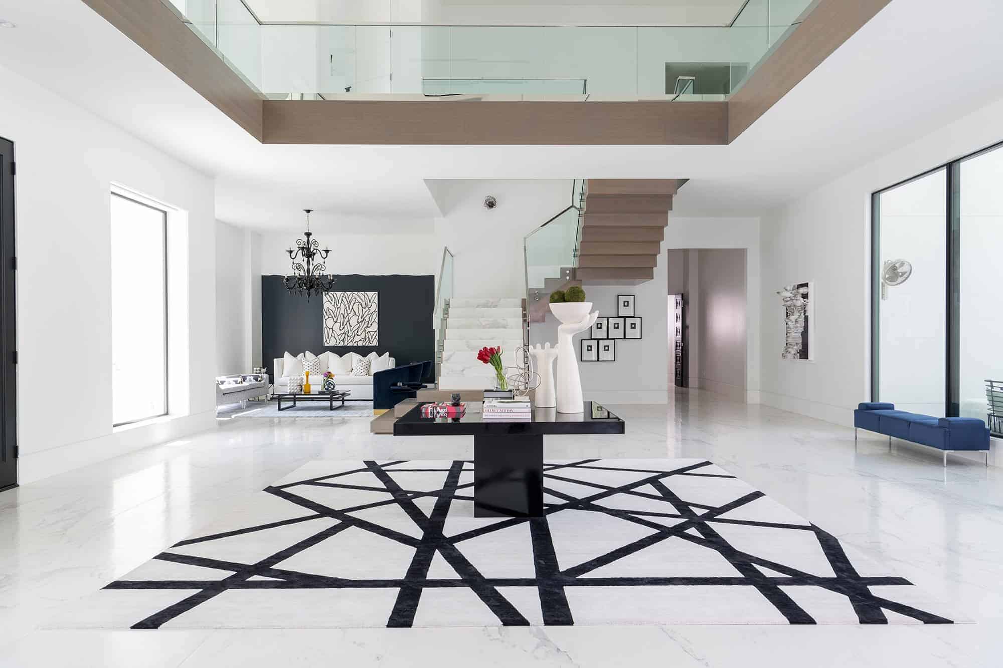 Contemporary grand entry way with black and white geometric rug - Laura U Interior Design