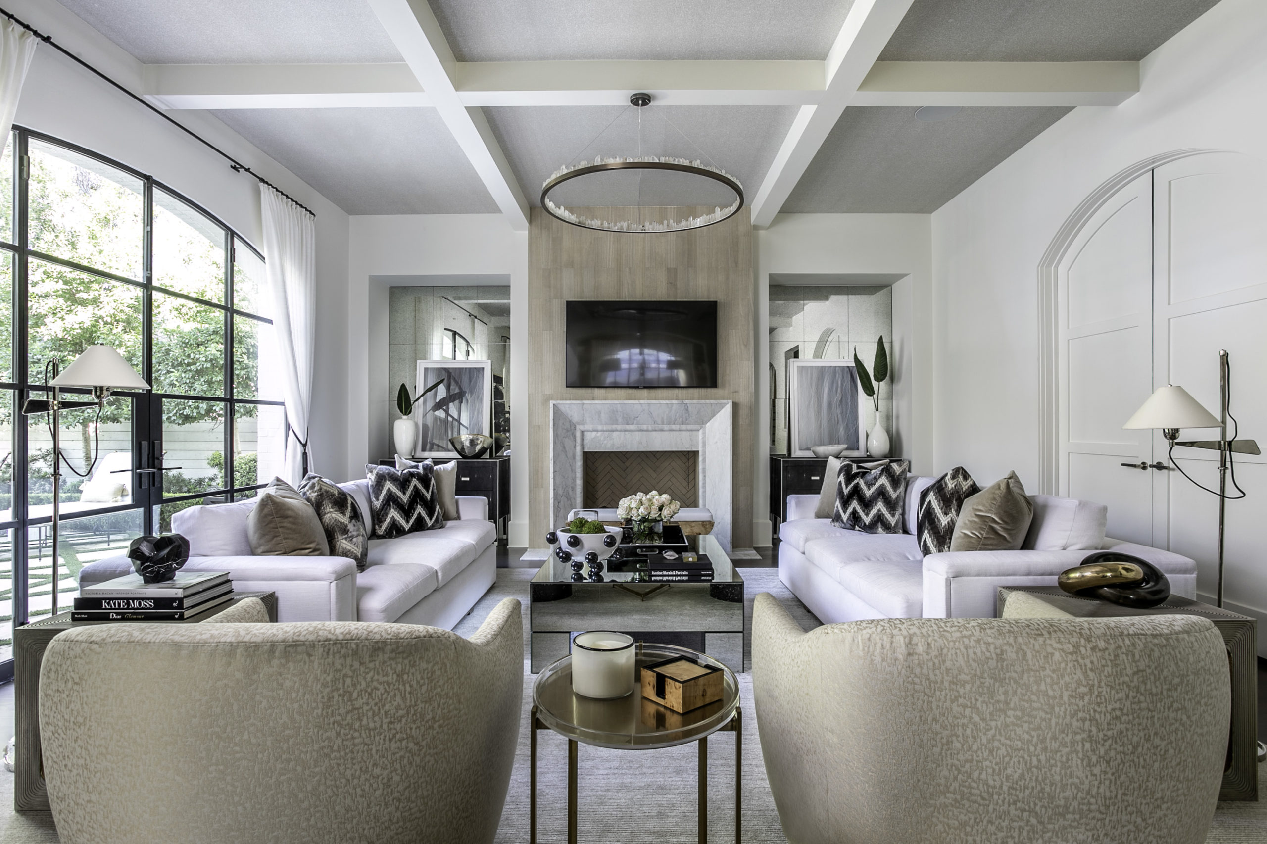 A coffered ceiling draws the eye upward in this symmetrical living room designed by Laura U