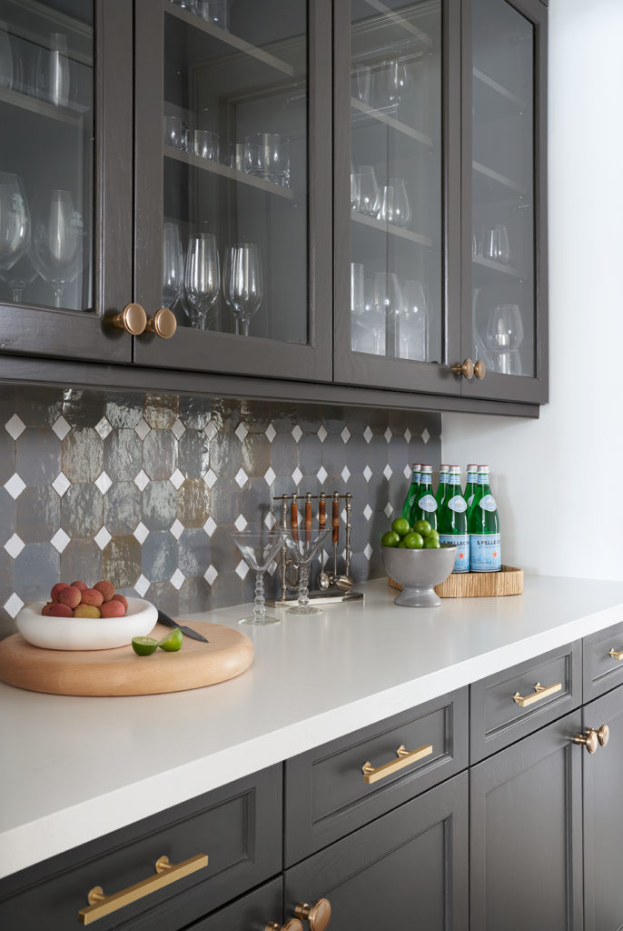 Geometric mosaic tile backsplash in the kitchen pantry