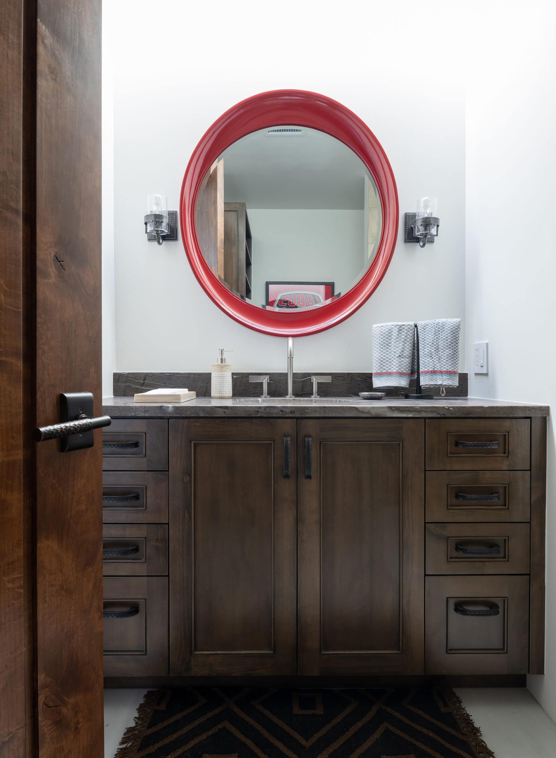 The mirror adds a beautiful pop of color to the guest bathroom