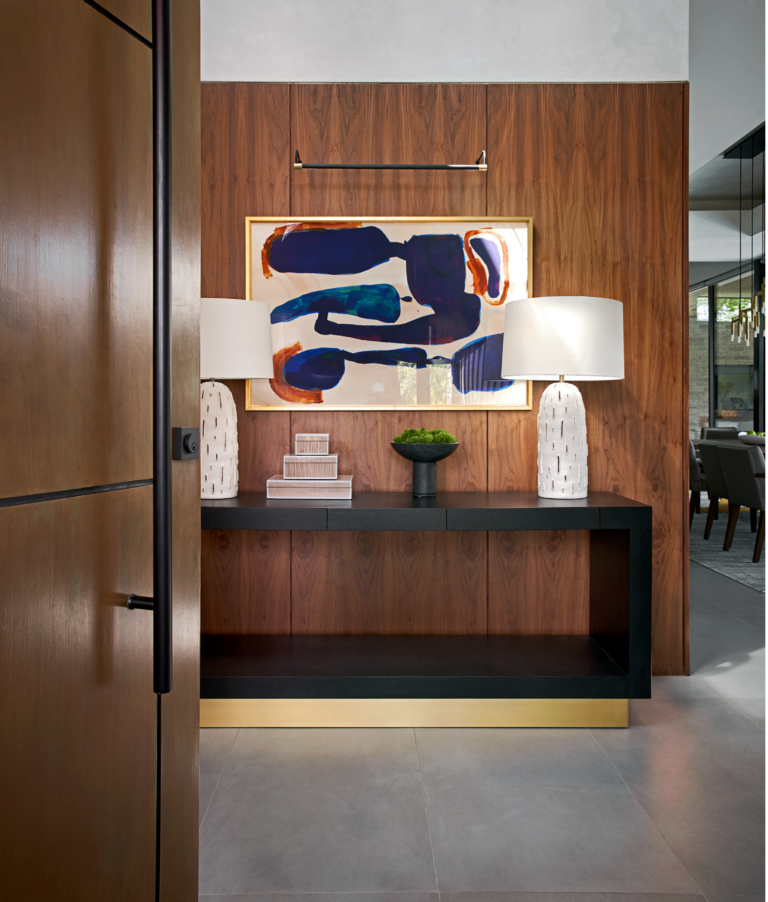 A walnut entryway channels mid-century design in this Houston home designed by Laura U Design Collective