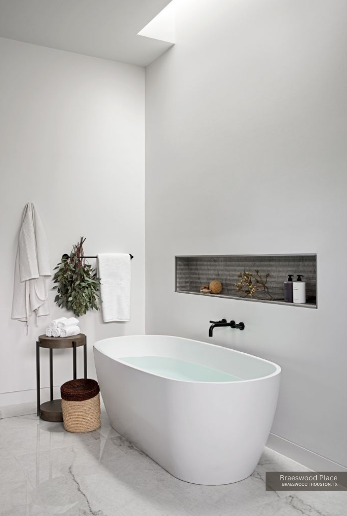 a contrasting niche above the white tub in this neutral bathroom