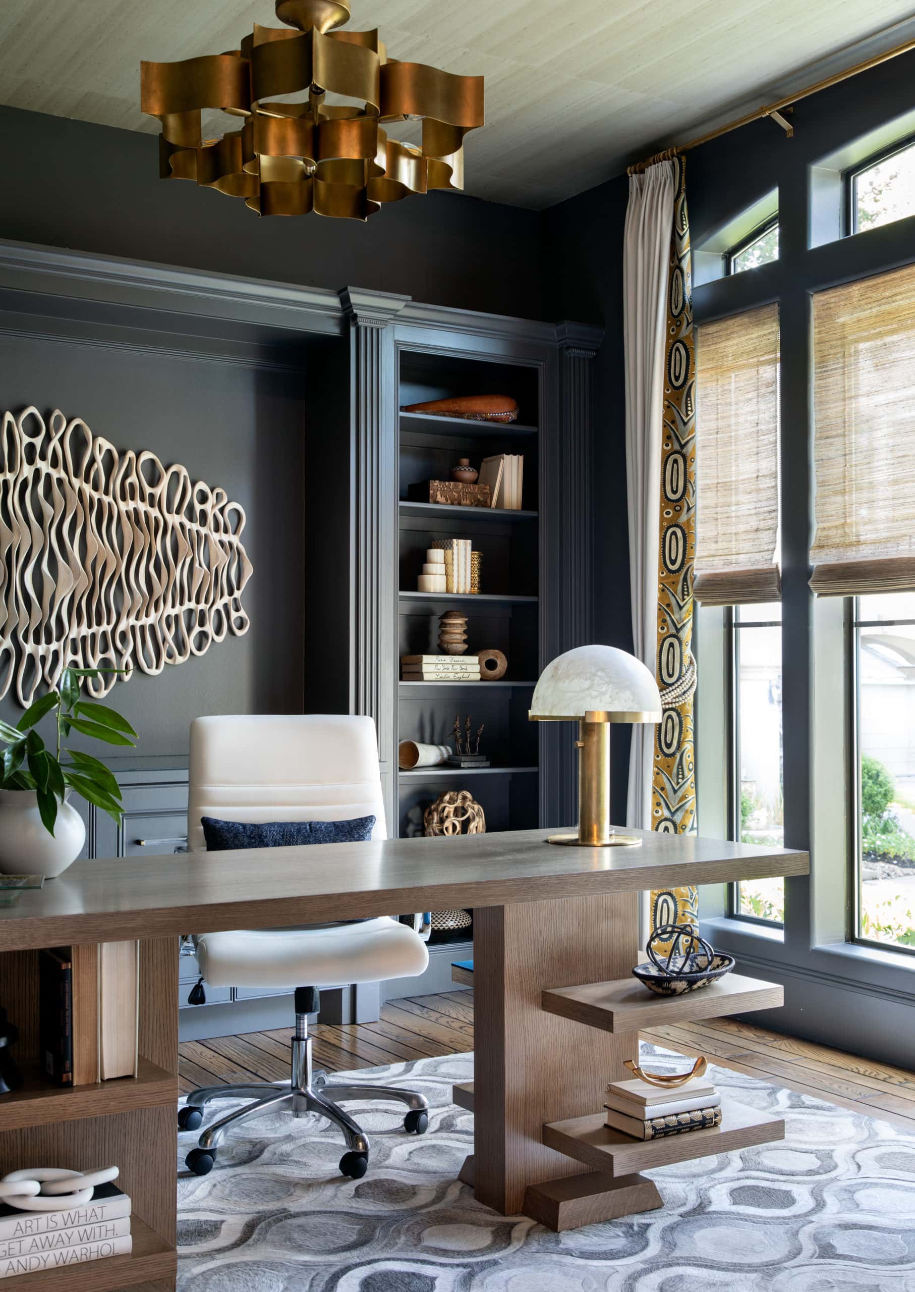 A moody study with artwork from Caprice Pierruci in a home designed by Laura U