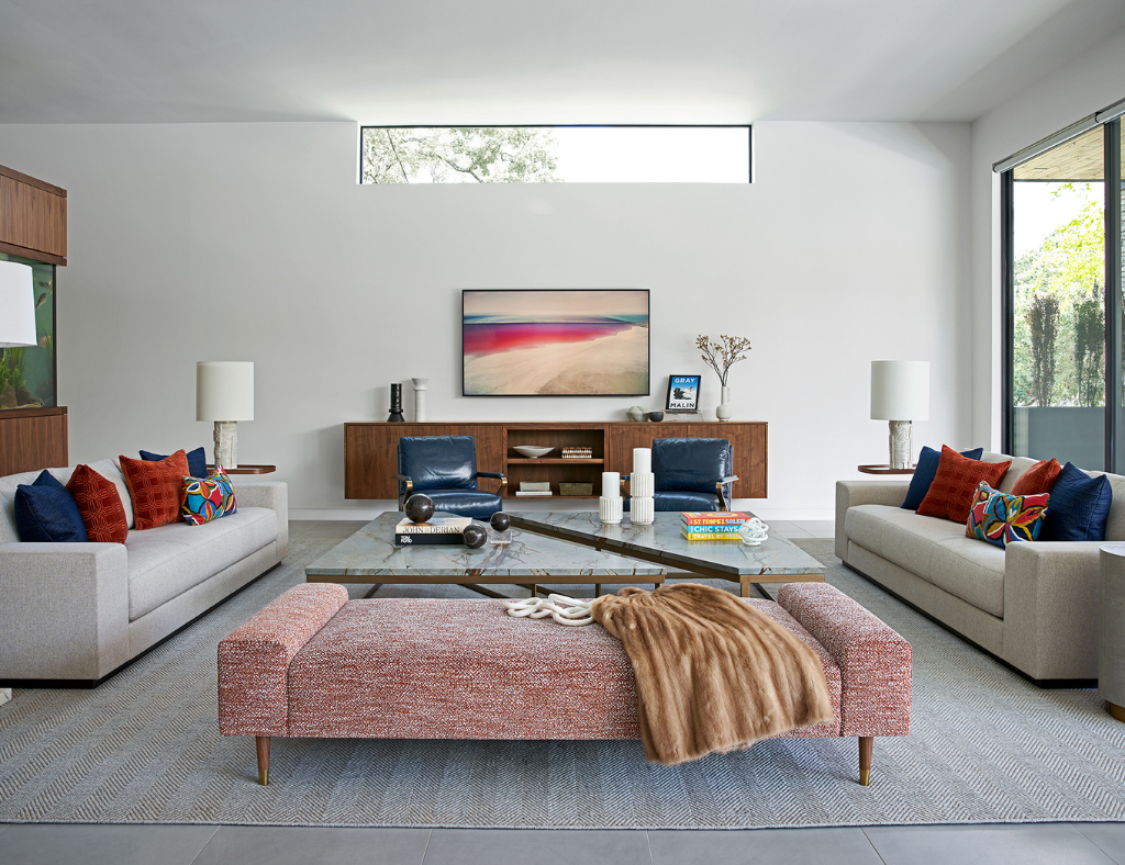 Tones of a Southwestern sunset throughout the artwork, throw pillows and living room furniture create a serene family space at Braeswood Place.