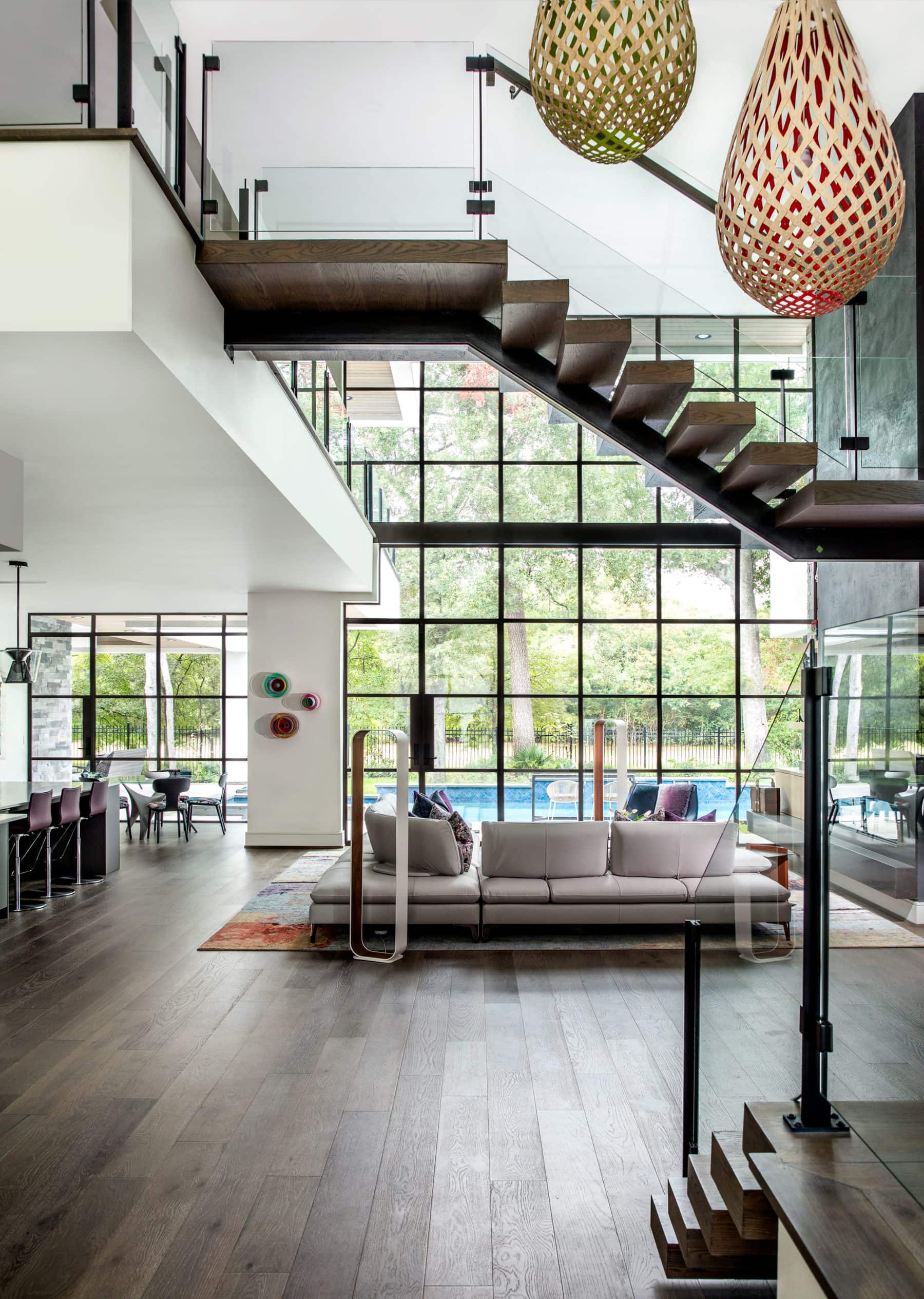 View into a Memorial area home with massive windows and modern staircase