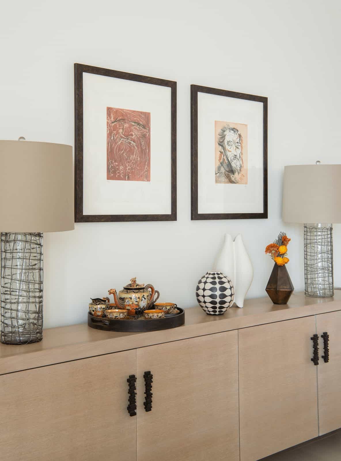 A large console table with glass lamps and the homeowner