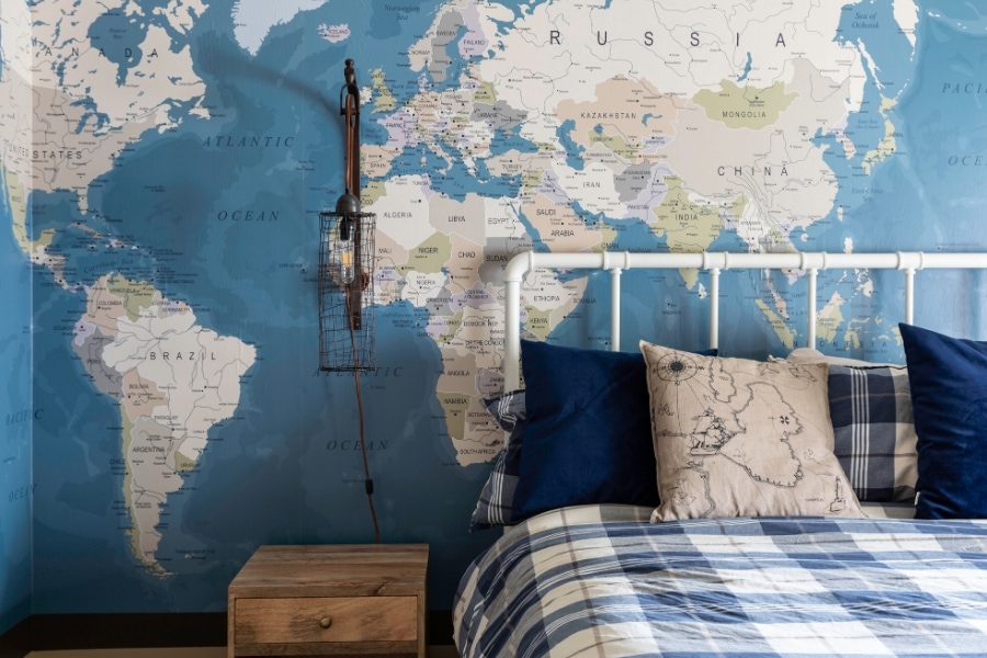 Blue and white boys bedroom with map wallpaper by Laura U