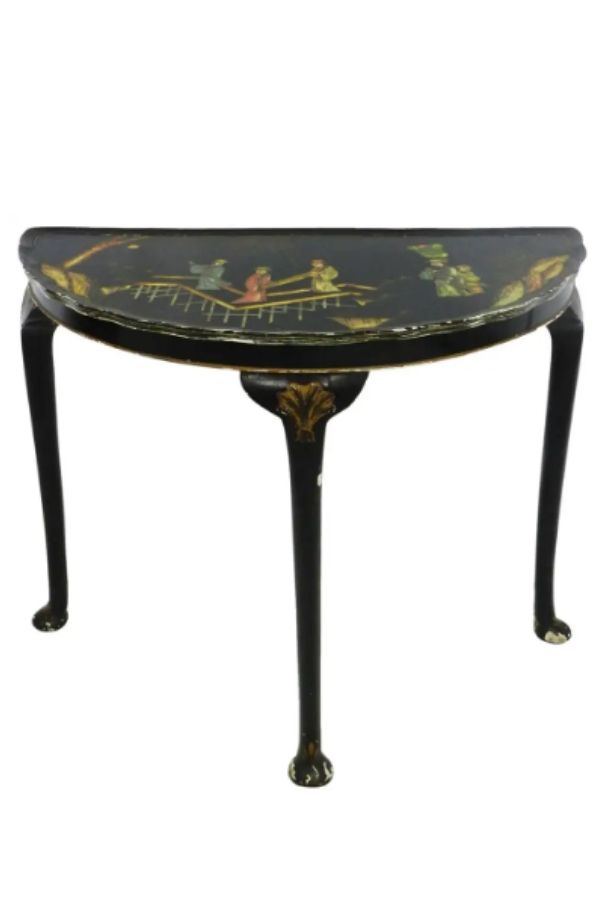 A dark brown console table with a chinoiserie design.