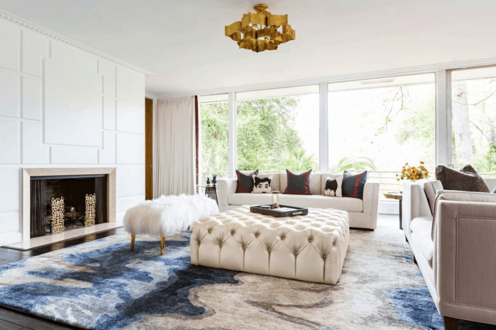 Mid century modern living room featuring white leather ottoman designed by Laura U Interior Design