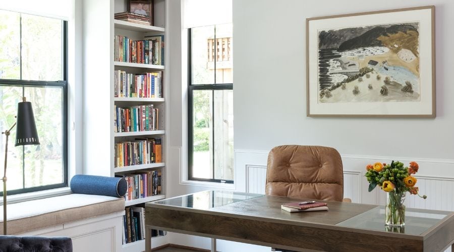 Modern home office in Houston with bookshelf and leather chair