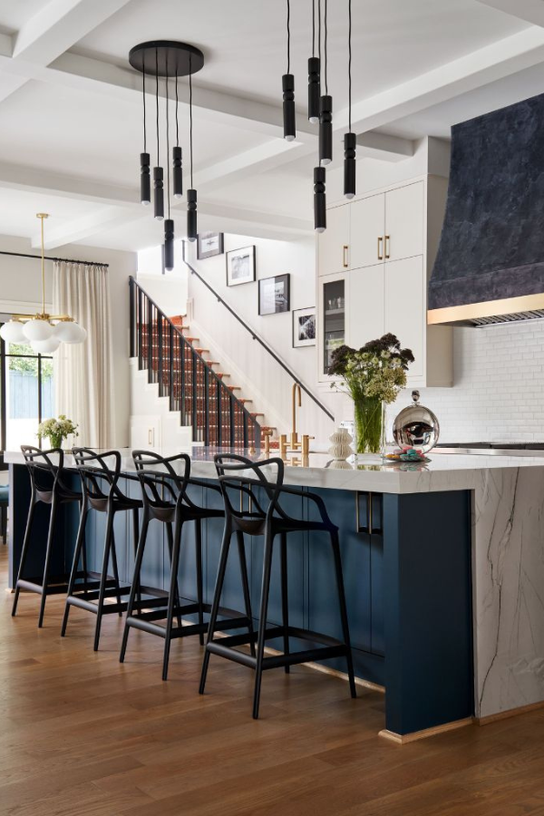 Overbrook kitchen with textured, painted vent hood and cascading pendant lights