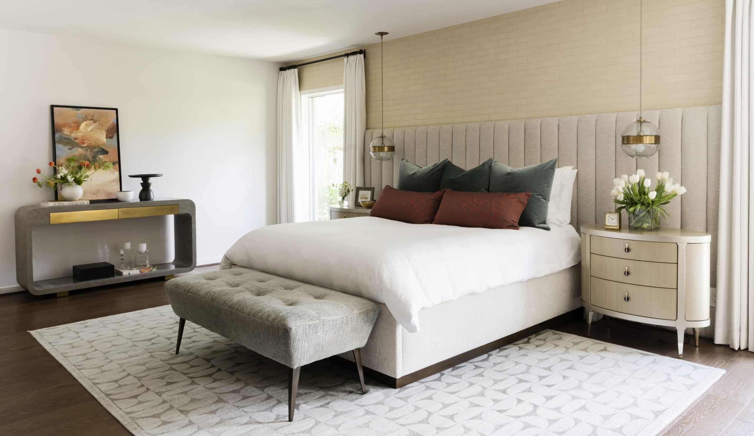 The master bedroom at Green Tree, with upholstered headboard and bench. Interior Design by Laura U Design Collective.