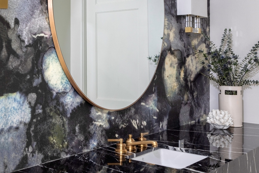 Organic black stone backsplash and counter tops brass bathroom fixtures